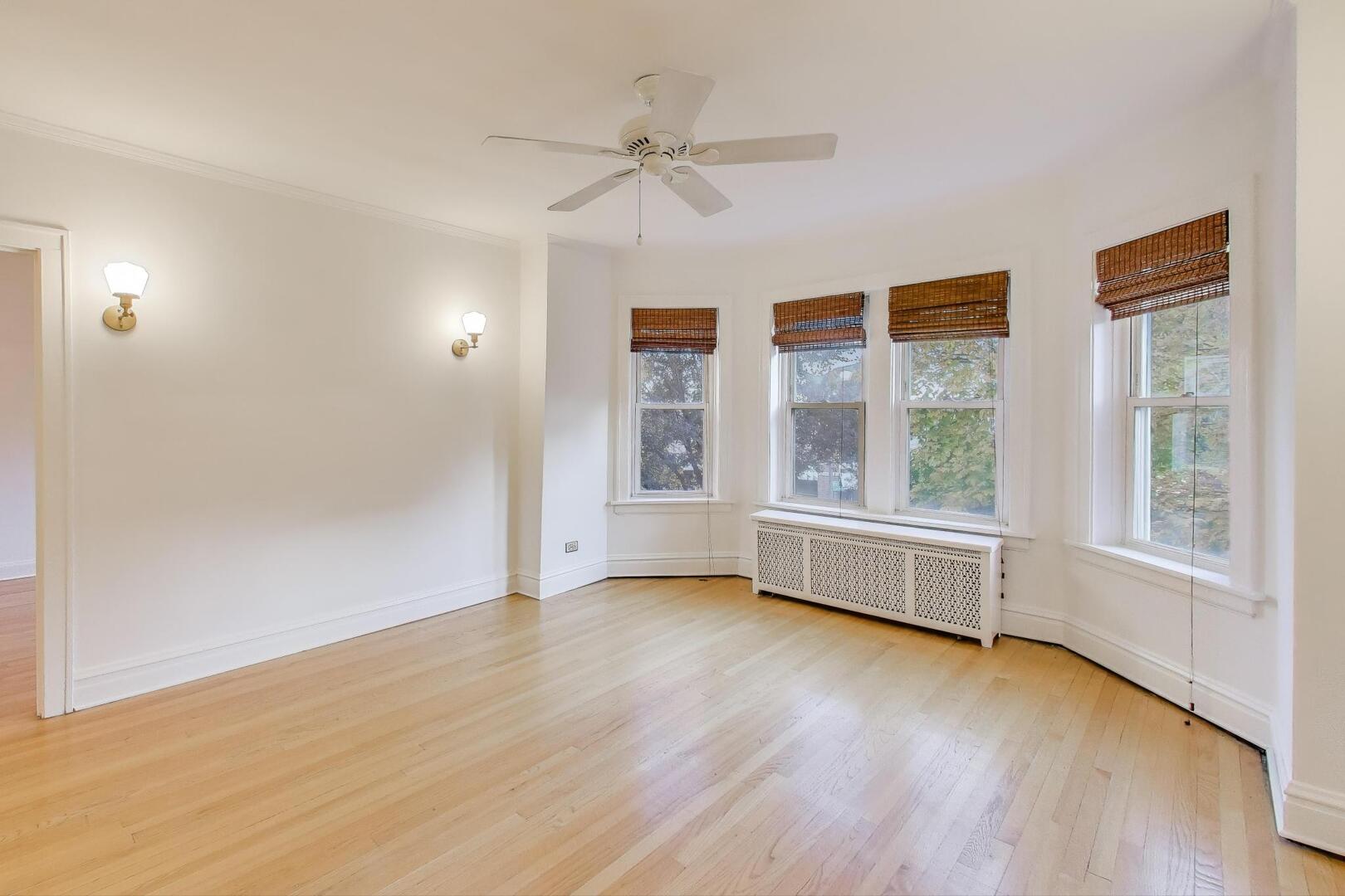 7346 Lake Street, Unit 2W River Forest, IL 60305 - Photo 4 of 30 a view of an empty room with a window and wooden floor