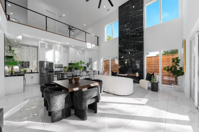 a dining hall with couches a coffee table and chairs