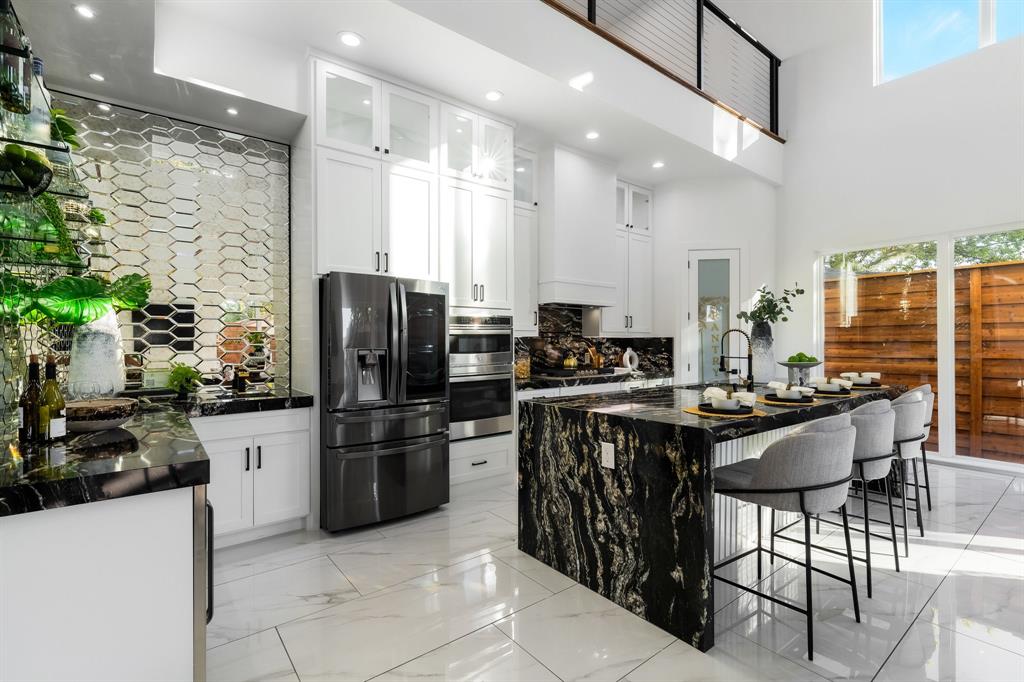 3351 Sylvan Avenue Dallas, TX 75212 - Photo 18 of 40 a kitchen with stainless steel appliances kitchen island granite countertop a refrigerator a stove a sink and a microwave