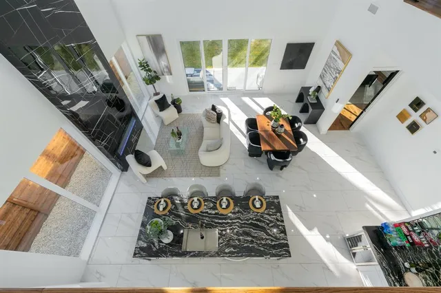 a view of living room with furniture and a floor to ceiling window