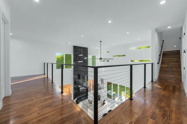 a kitchen with stainless steel appliances a refrigerator and a wooden floor