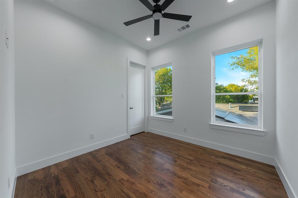 3351 Sylvan Avenue Dallas, TX 75212 - Photo 34 of 40 an empty room with windows and a ceiling fan