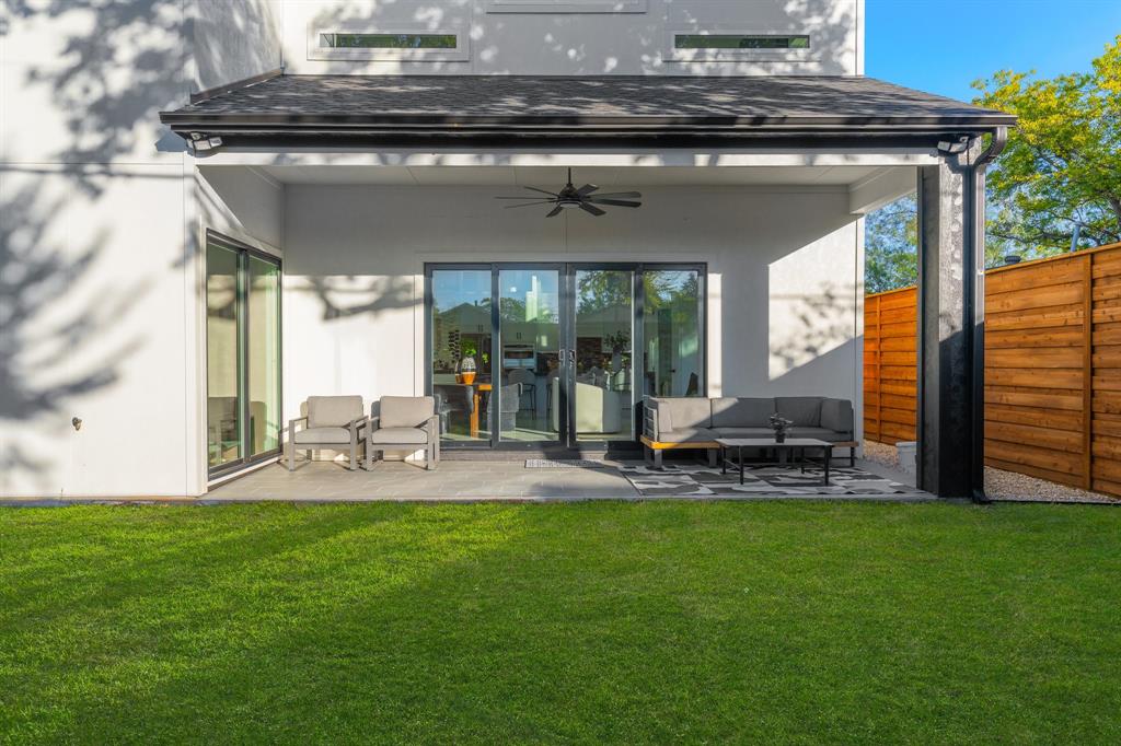 3351 Sylvan Avenue Dallas, TX 75212 - Photo 38 of 40 a view of a backyard with table and chairs and wooden fence