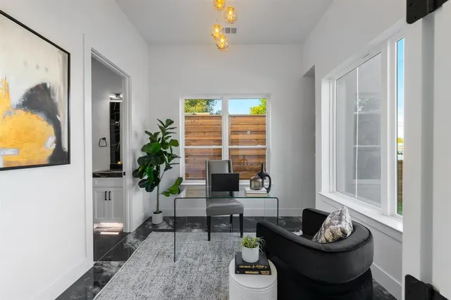 a living room with furniture and a potted plant