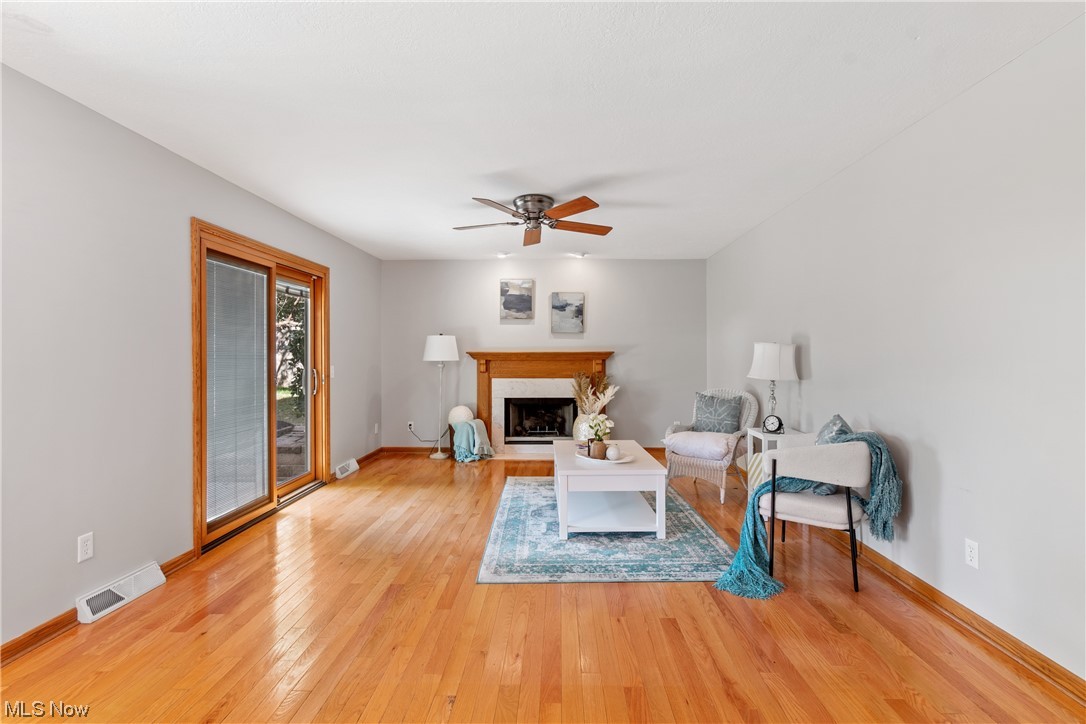 1819 Beryl Road Akron, OH 44312 - Photo 13 of 35 Living room with a fireplace, light hardwood floors, and ceiling fan