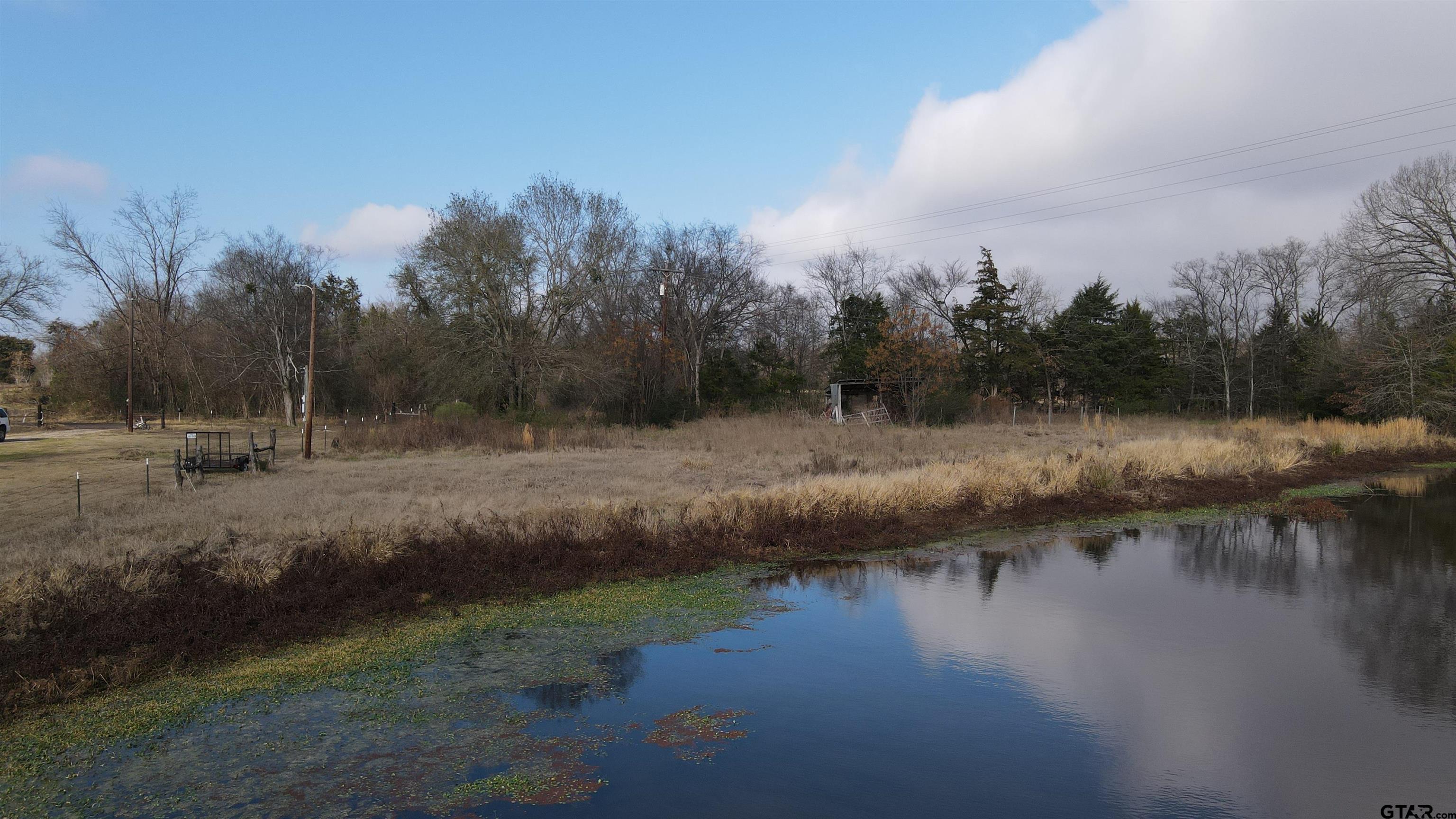 3486 County Road 2324 Como, TX 75431 - Photo 5 of 7 a view of a water pond with green space