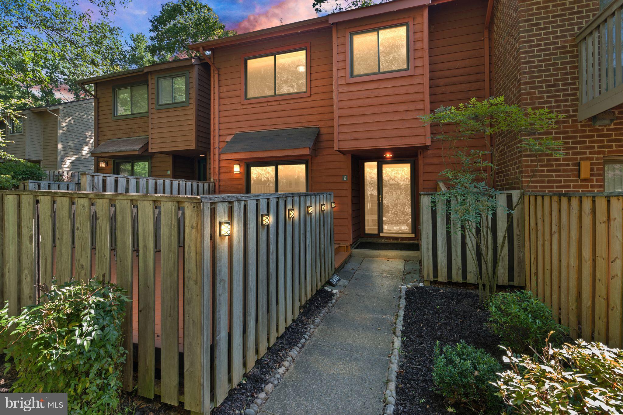a view of a house with a small yard and plants