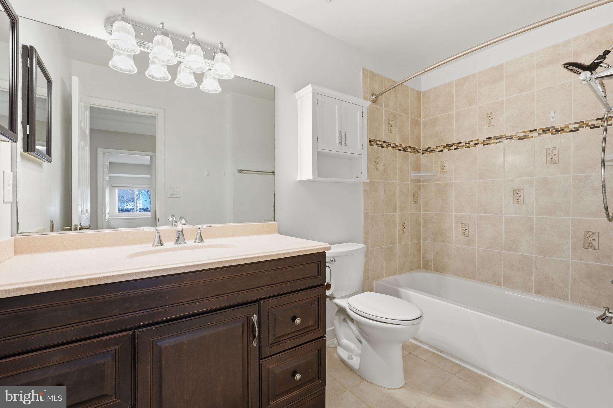 1942 Winterport Cl Reston, VA 20191 - Photo 16 of 19 a bathroom with a sink a toilet and a mirror