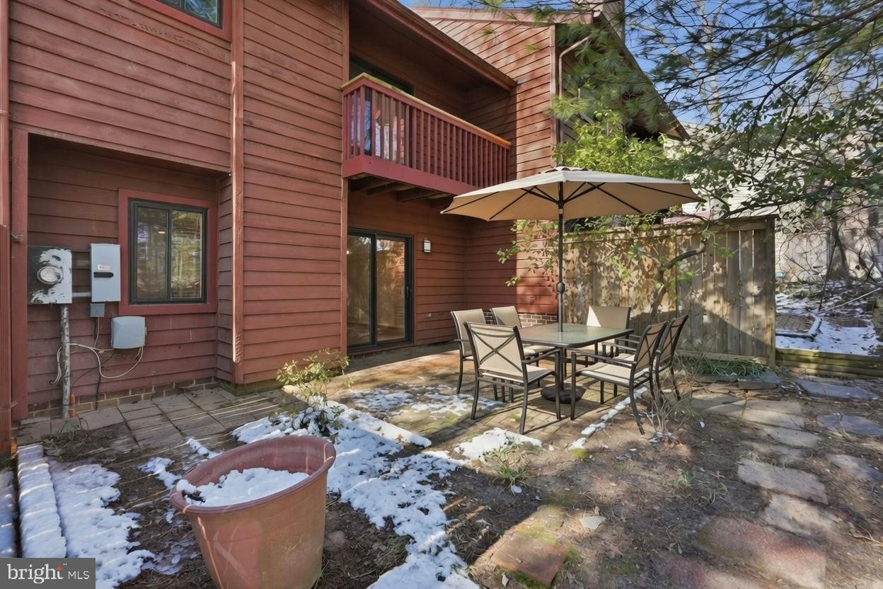 1942 Winterport Cl Reston, VA 20191 - Photo 19 of 19 a view of a patio with table and chairs under an umbrella
