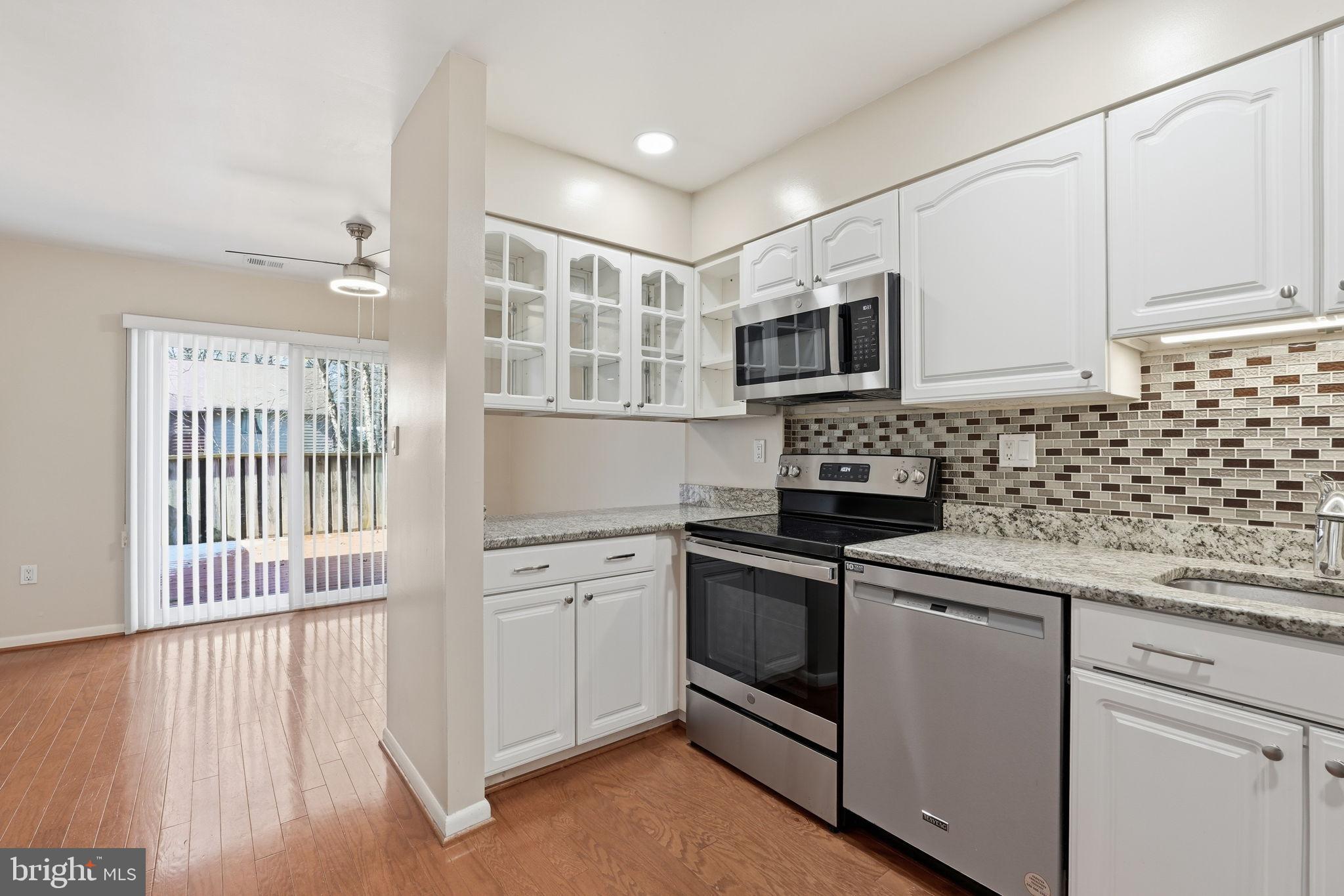 1942 Winterport Cl Reston, VA 20191 - Photo 5 of 19 a kitchen with stainless steel appliances granite countertop a stove and a sink