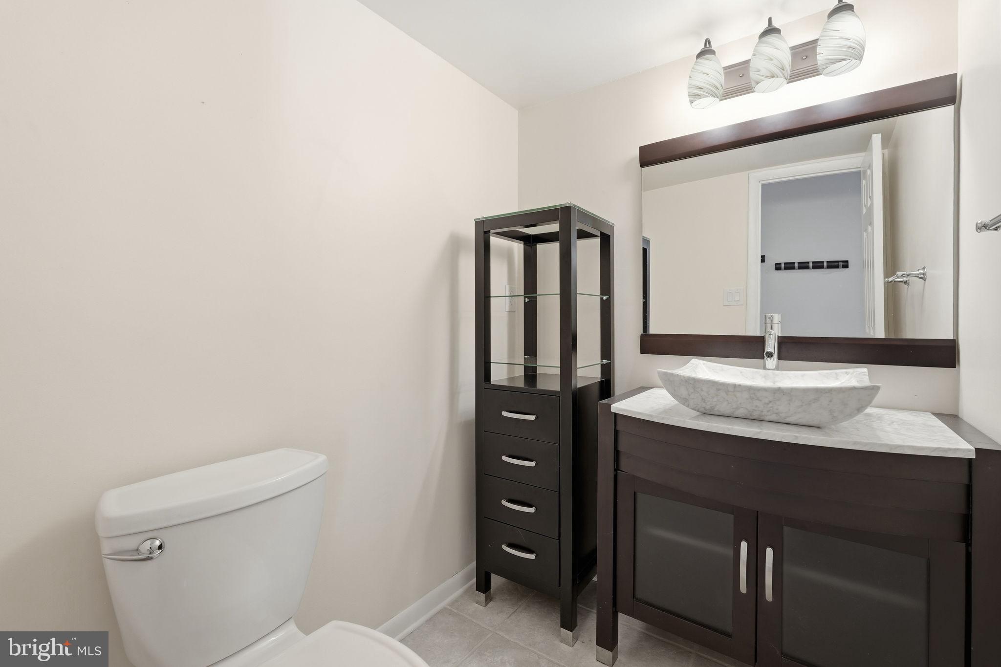 1942 Winterport Cl Reston, VA 20191 - Photo 9 of 19 a bathroom with a granite countertop sink toilet and mirror