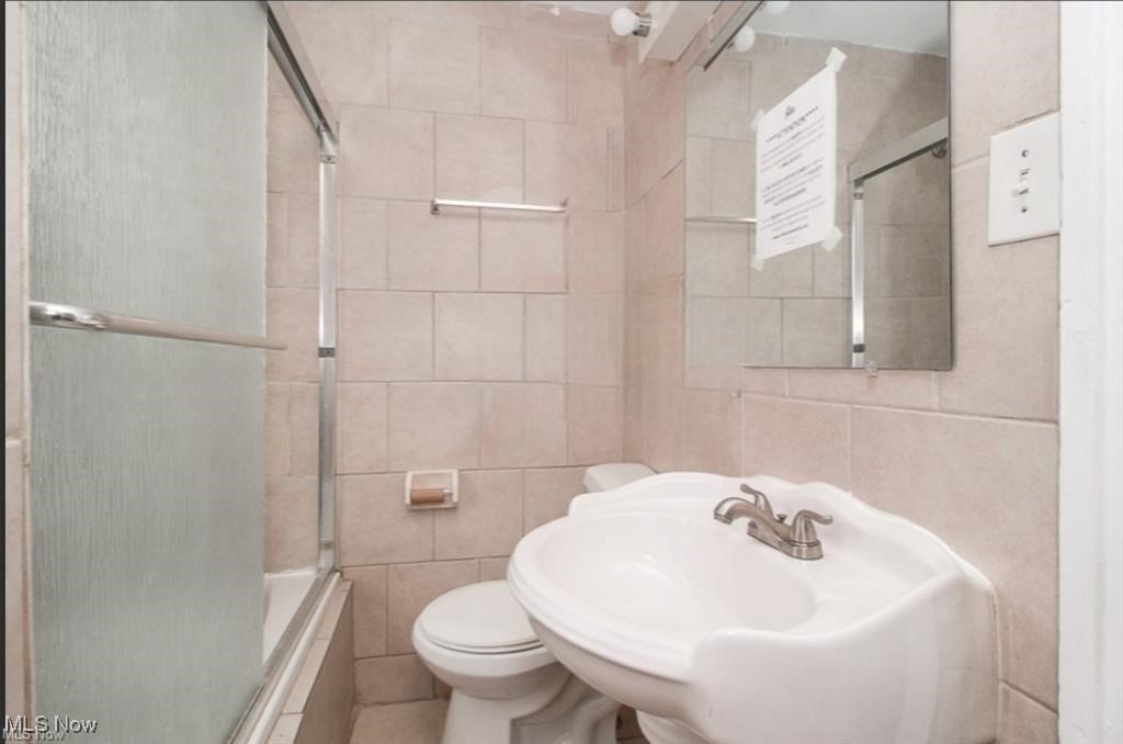855 Roanoke Road Cleveland Heights, OH 44121 - Photo 9 of 14 Bathroom featuring tile walls, toilet, and a sink