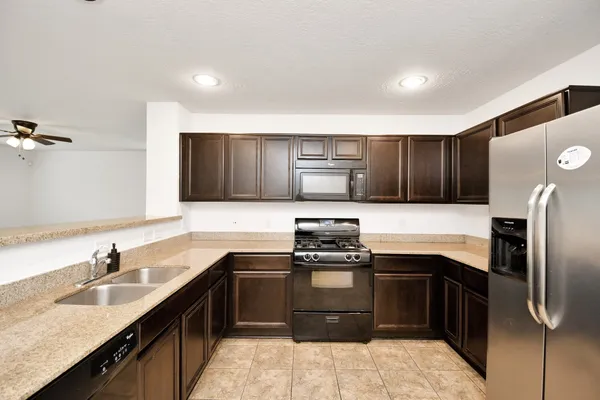 a view of a kitchen with a sink and dishwasher