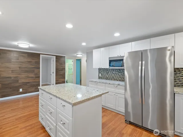a kitchen with stainless steel appliances a refrigerator and a sink