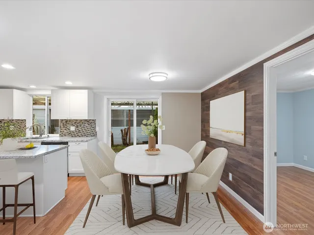 a view of a dining room with furniture window and wooden floor