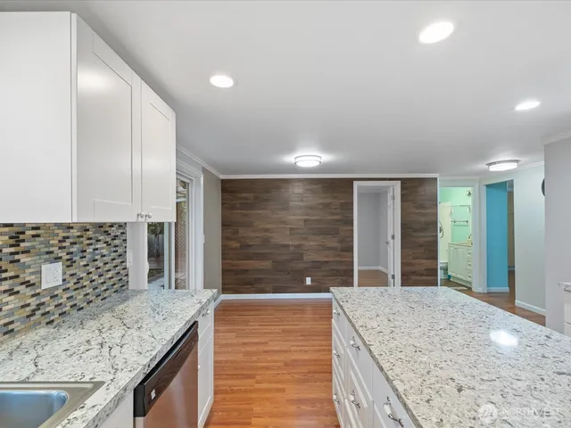 a bathroom with a granite countertop sink and a large mirror