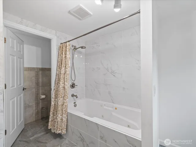 a bathroom with a bathtub and shower
