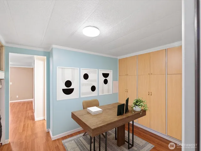 a view of a workspace with furniture and wooden floor