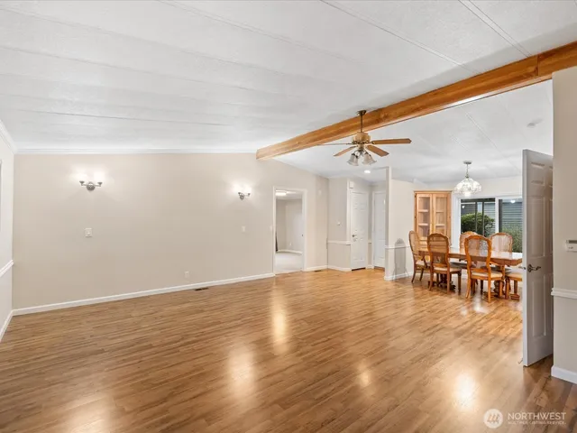 an empty room with wooden floor and outdoor seating