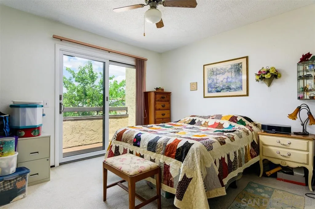 9204 Mast Boulevard, Unit 40 Santee, CA 92071 - Photo 13 of 21 a bedroom with a bed and a chandelier