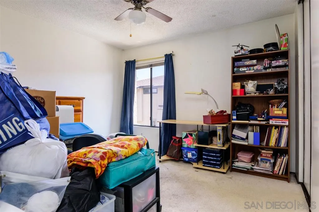 9204 Mast Boulevard, Unit 40 Santee, CA 92071 - Photo 16 of 21 a bedroom with furniture and a book shelf