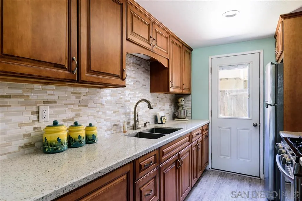 9204 Mast Boulevard, Unit 40 Santee, CA 92071 - Photo 9 of 21 a kitchen with stainless steel appliances a sink a stove cabinets and a window