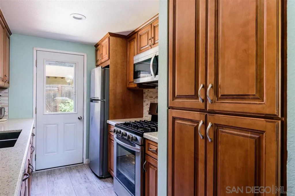 9204 Mast Boulevard, Unit 40 Santee, CA 92071 - Photo 10 of 21 a kitchen with stainless steel appliances a refrigerator and a stove top oven