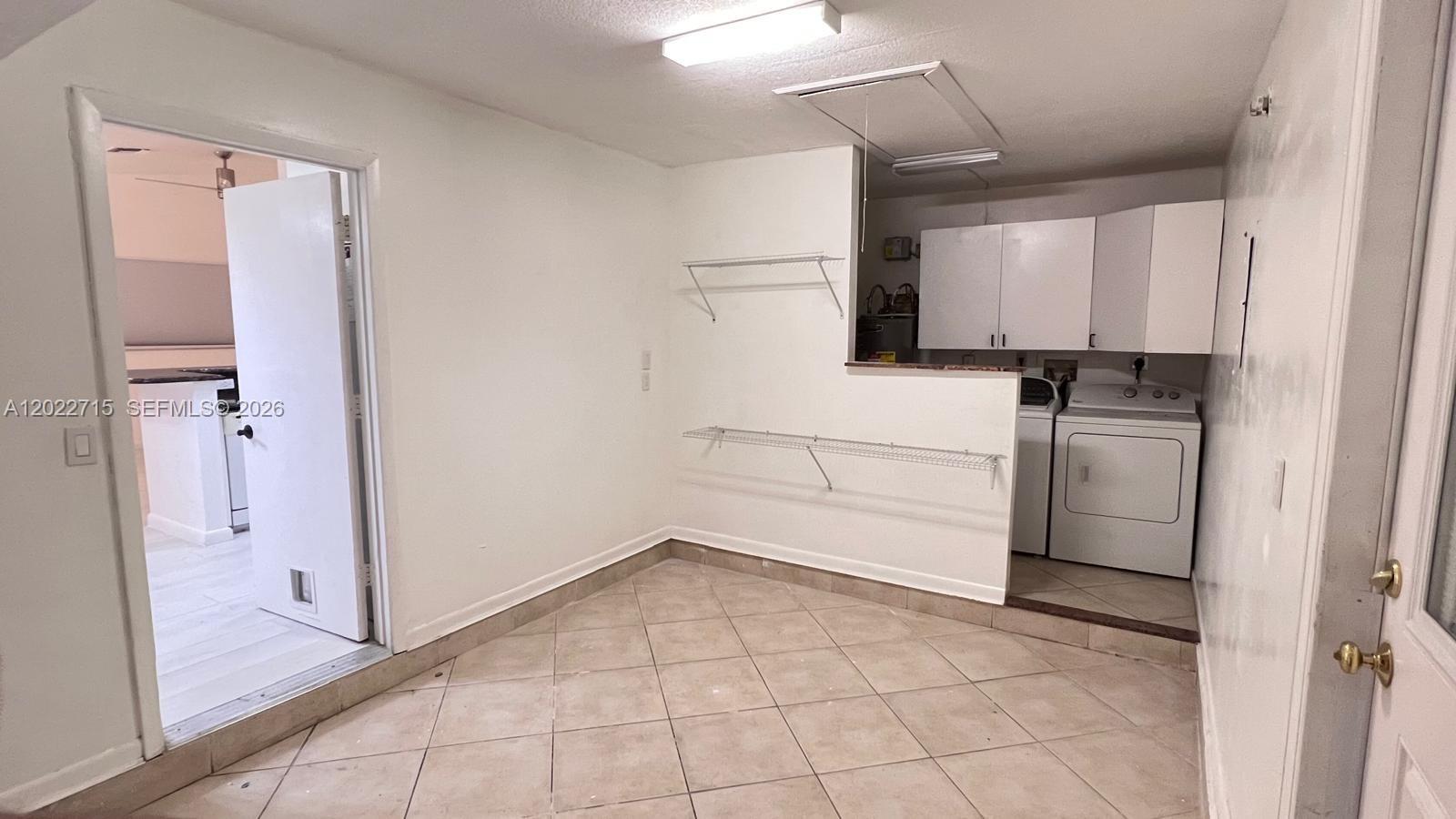 10669 Boca Entrada Boulevard Boca Raton, FL 33428 - Photo 17 of 19 a kitchen with white cabinets and white appliances