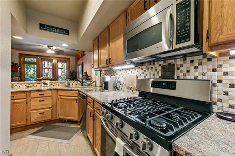 a kitchen with stove and cabinets
