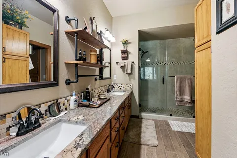 a bathroom with double vanity and a bathtub