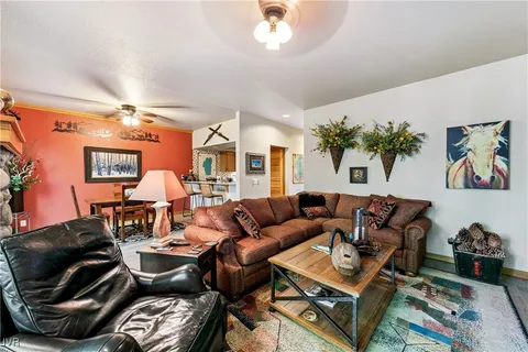 a living room with furniture and a chandelier