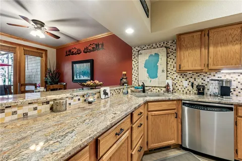 a kitchen with sink stove and cabinets