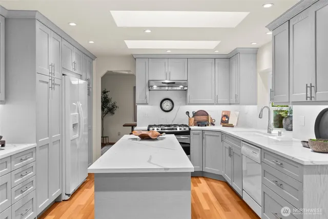 a living room with furniture and floor to ceiling windows