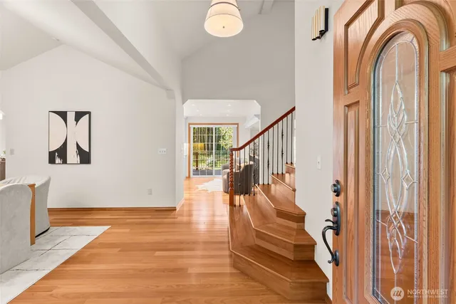 a view of a dining room with furniture a chandelier and wooden floor