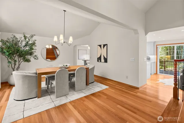 a kitchen with stainless steel appliances granite countertop a sink and a large window