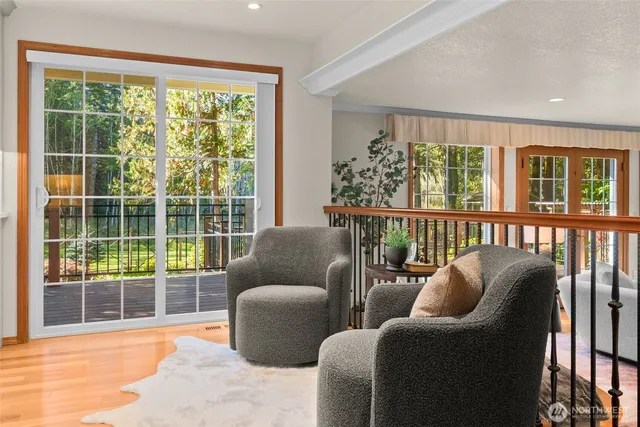 a living room with furniture a fireplace and a large window