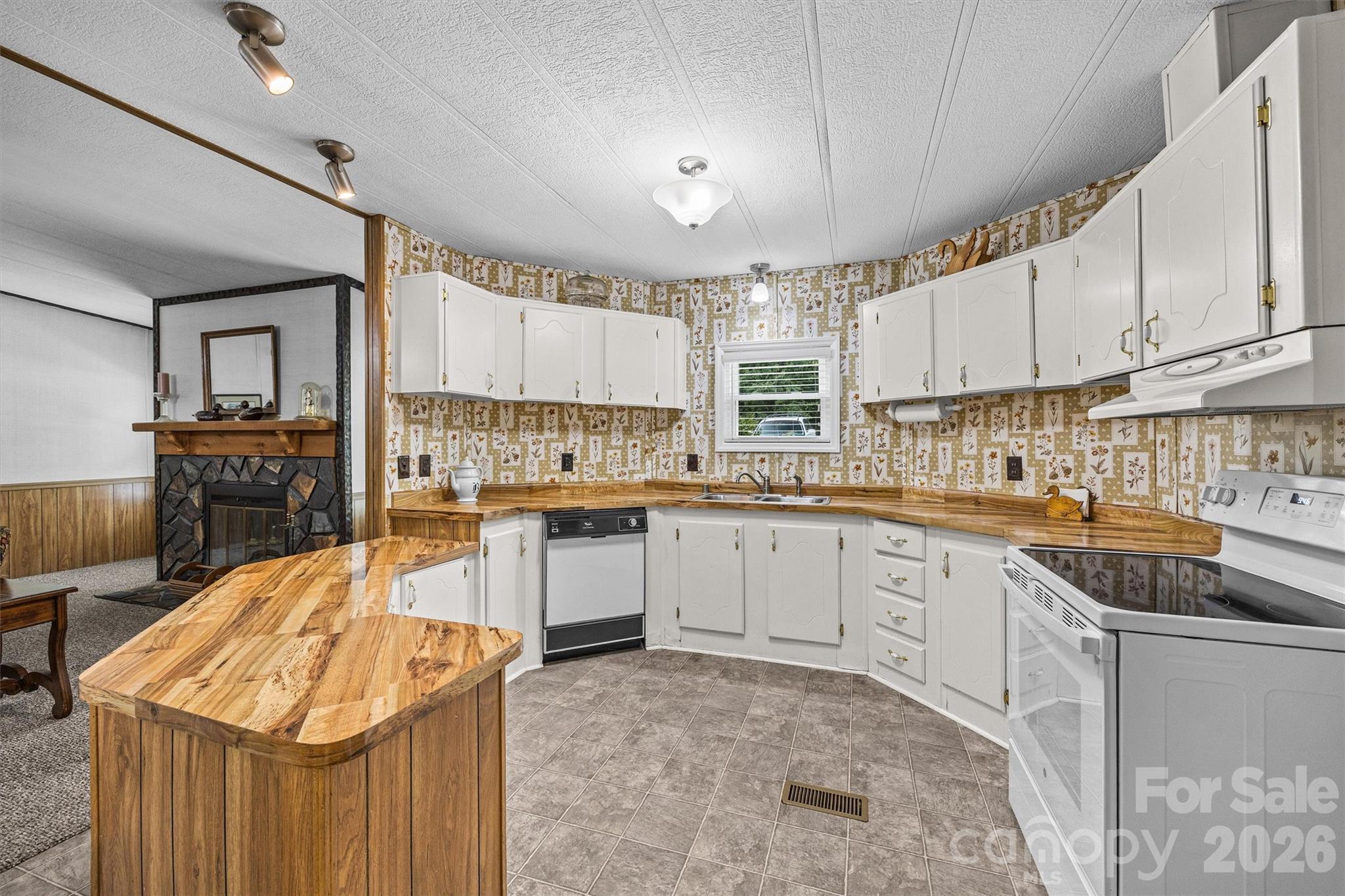 2071 Chameleon Road, Unit 156 York, SC 29745 - Photo 6 of 46 a kitchen with kitchen island granite countertop a sink stove and cabinets