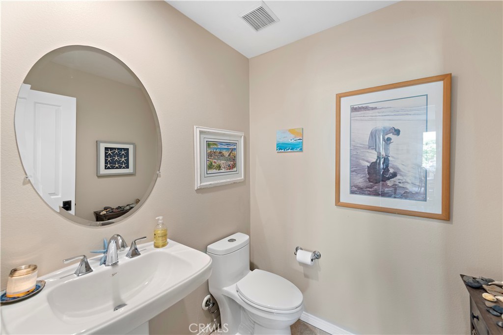 15 Corte Limonada San Clemente, CA 92673 - Photo 16 of 64 a bathroom with a toilet a sink and mirror