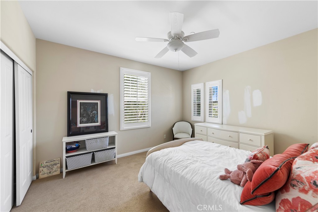 15 Corte Limonada San Clemente, CA 92673 - Photo 42 of 64 a bedroom with a bed and a chandelier