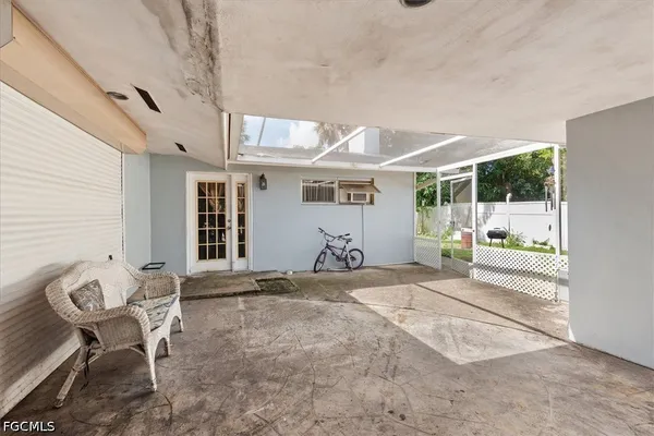 a view of a chair and table in backyard of the house