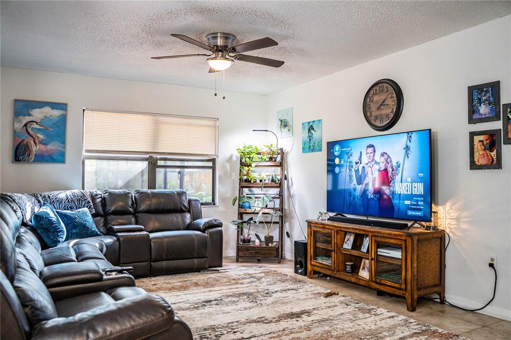 207 24th Court Southwest Winter Haven, FL 33880 - Photo 12 of 75 a living room with furniture a window and a flat screen tv