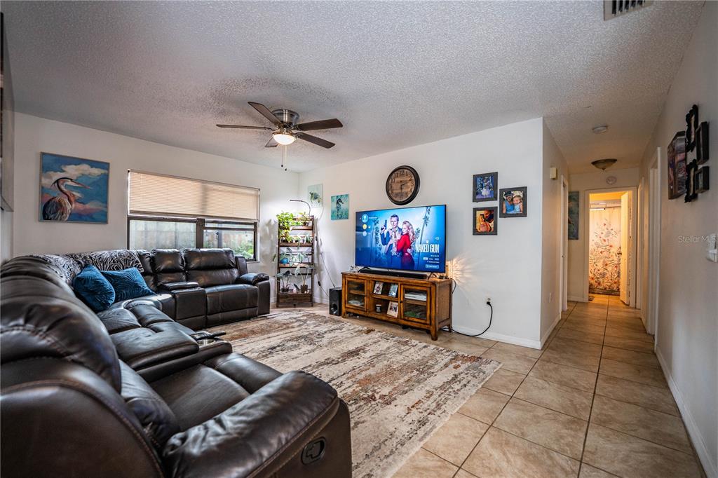 207 24th Court Southwest Winter Haven, FL 33880 - Photo 13 of 75 a living room with furniture and a flat screen tv