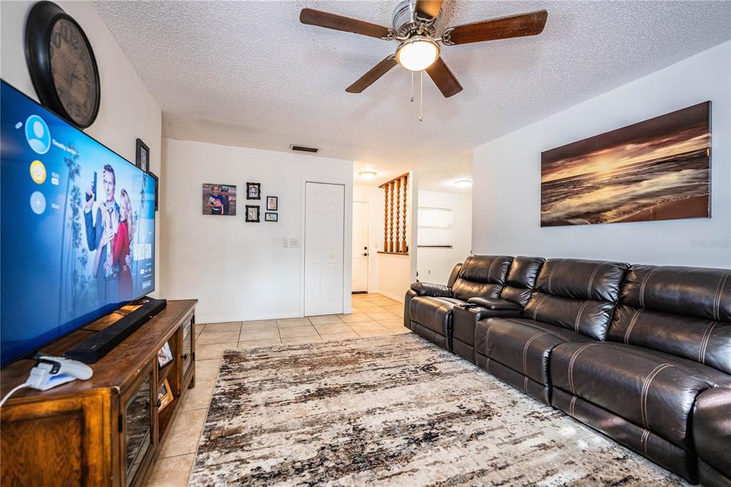 207 24th Court Southwest Winter Haven, FL 33880 - Photo 14 of 75 a living room with furniture and a flat screen tv