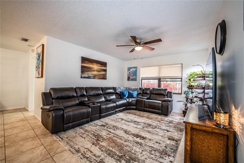 207 24th Court Southwest Winter Haven, FL 33880 - Photo 15 of 75 a living room with furniture window and a flat screen tv
