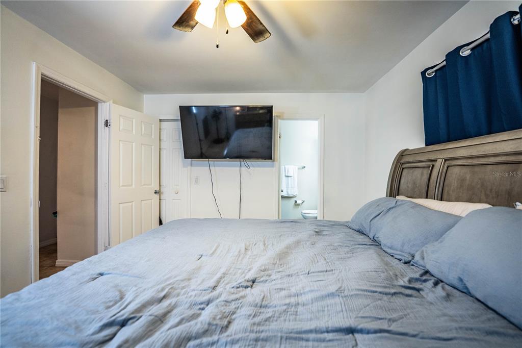 207 24th Court Southwest Winter Haven, FL 33880 - Photo 26 of 75 a bedroom with a bed and a flat screen tv
