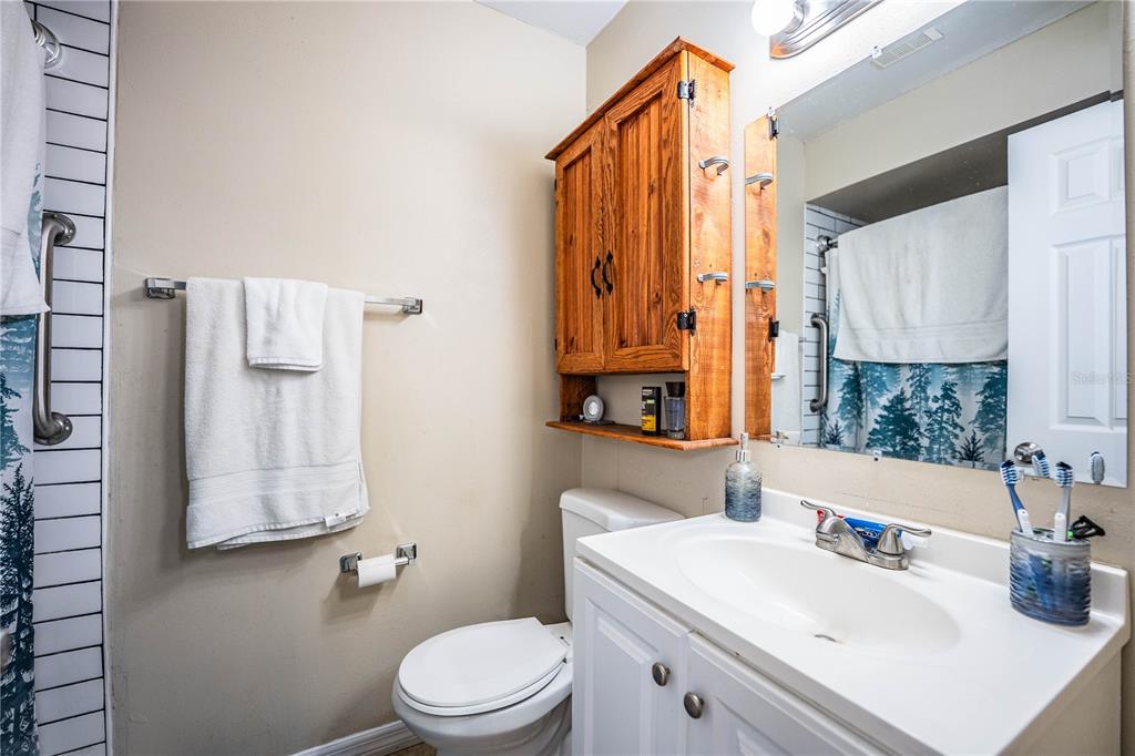 207 24th Court Southwest Winter Haven, FL 33880 - Photo 28 of 75 a bathroom with a sink a toilet and vanity
