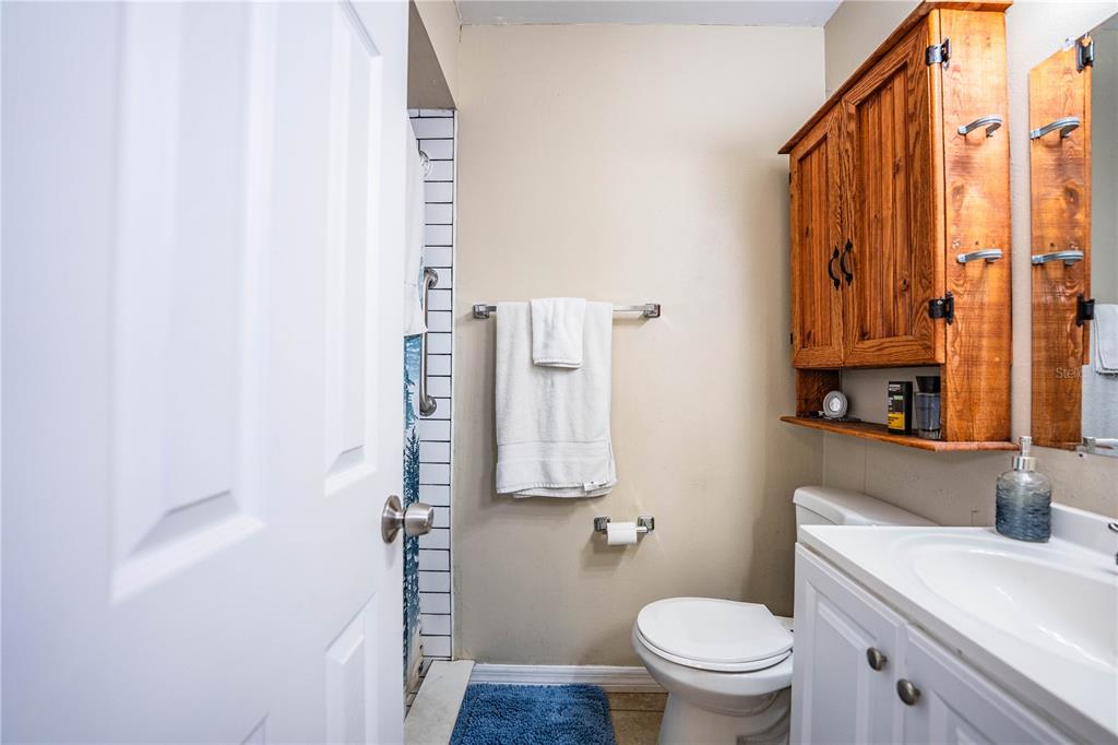 207 24th Court Southwest Winter Haven, FL 33880 - Photo 29 of 75 a bathroom with a toilet sink and mirror