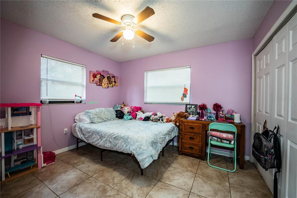 207 24th Court Southwest Winter Haven, FL 33880 - Photo 30 of 75 a bedroom with a bed and a chandelier