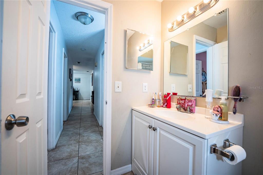 207 24th Court Southwest Winter Haven, FL 33880 - Photo 33 of 75 a bathroom with a sink vanity and a mirror