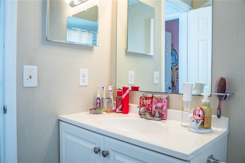 207 24th Court Southwest Winter Haven, FL 33880 - Photo 34 of 75 a bathroom with a sink and a mirror
